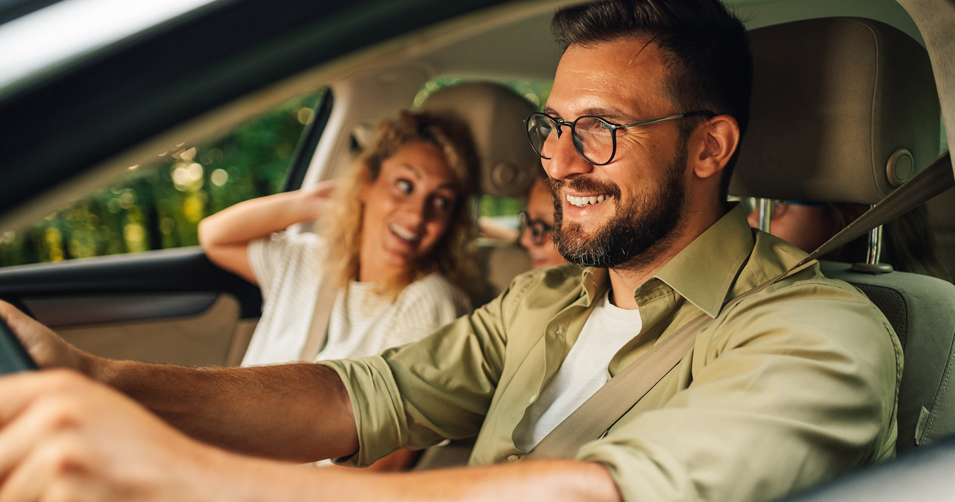 Why Buy From Cartopia46? Young family driving home in their pre-owned vehicle